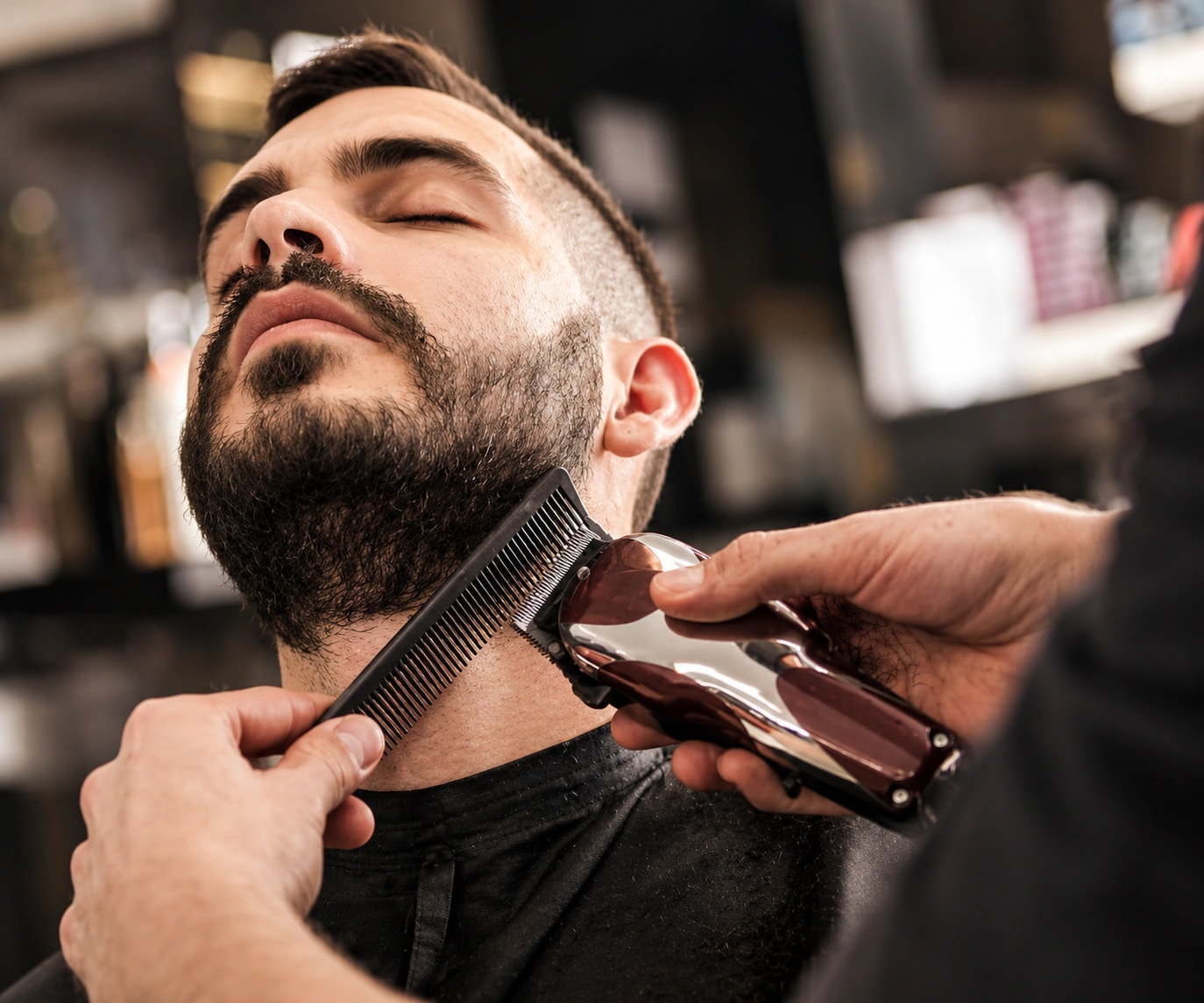 Beard being trimmed with a comb and clippers