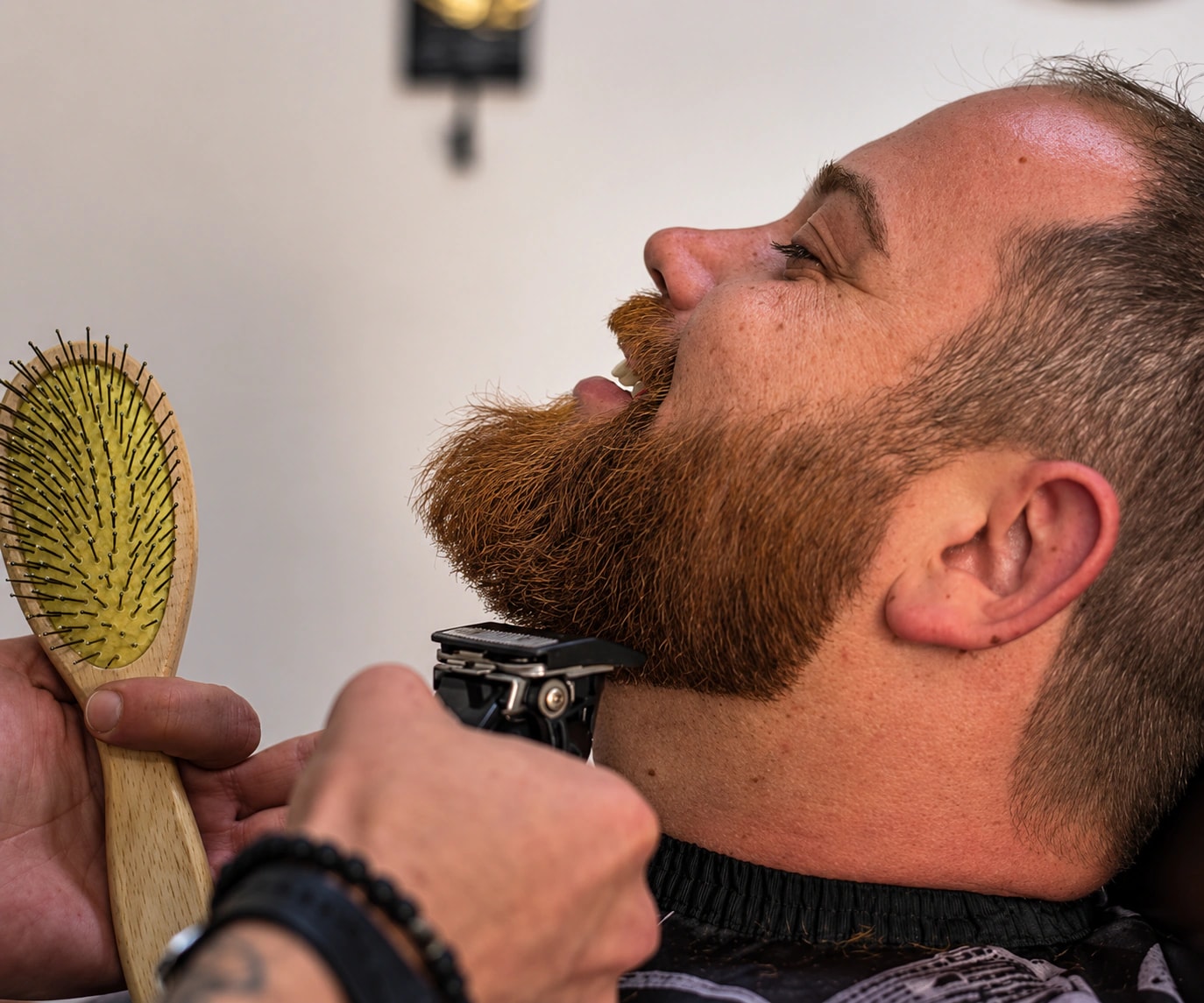 Barber defining beard edges with clippers